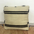 Handmade Moroccan kilim pouf featuring vertical stripe motifs, flatwoven Berber textile construction, and artisan handcrafted detailing.